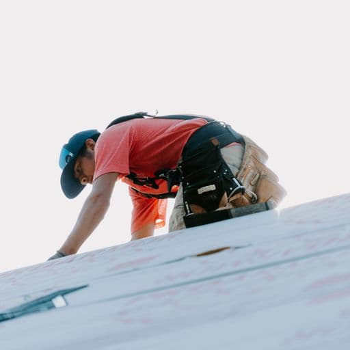 ARRT roofer working in safety harness