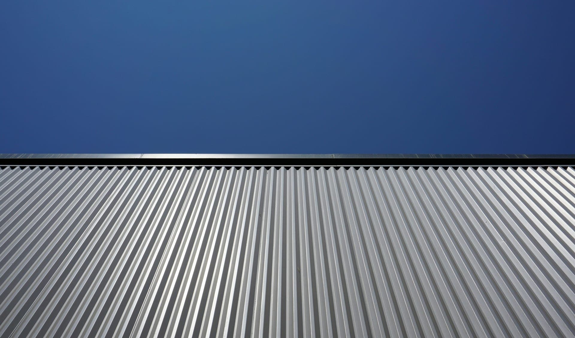 Corrugated metal roofing against a clear blue sky