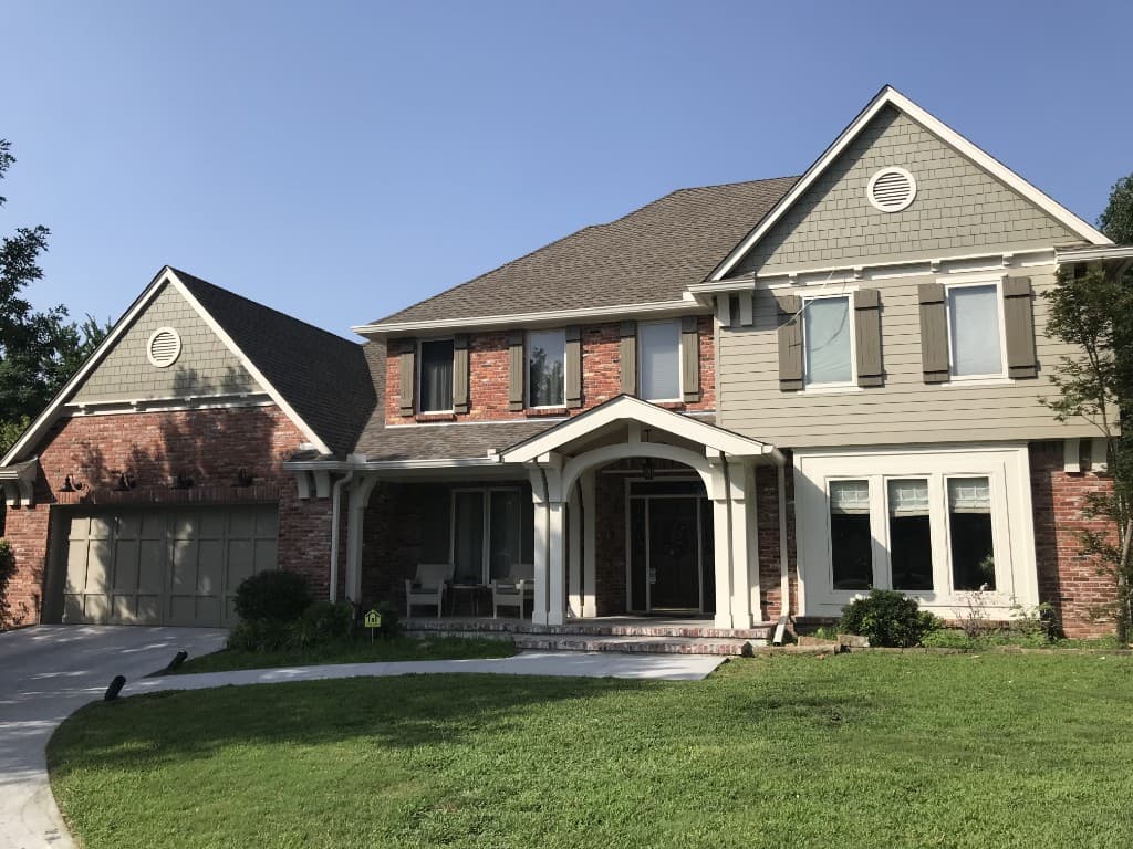 Brick home with new roof by ARRT