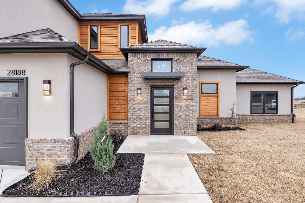 Modern home with mixed materials and dark roof