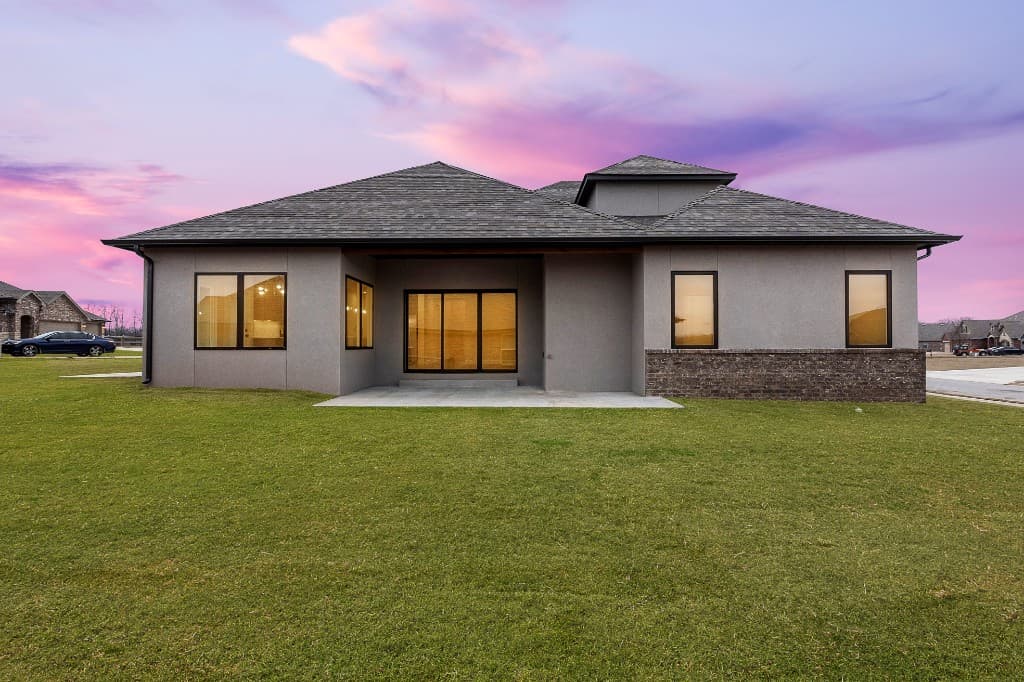 Modern home with dark roof at sunset